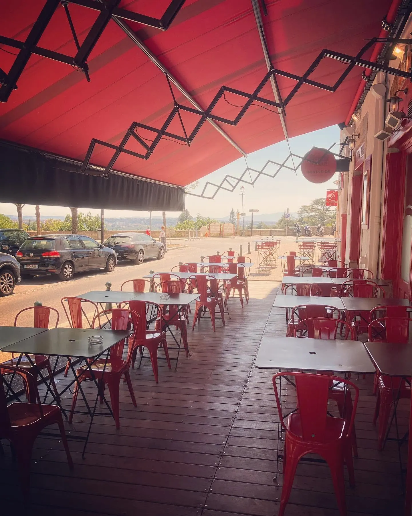 The terrace under the red awning, view over the Monts d'Or